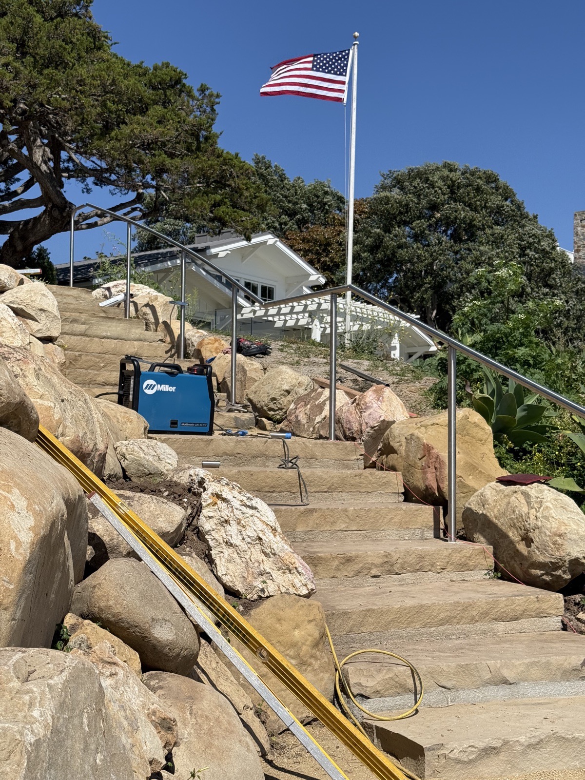 Stainless steel handrail installed along sandstone bluff steps